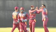 Qatar players celebrate after taking a wicket. Pictures: Abdul Basit / The Peninsula 


