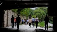 People wearing masks take a walk amid the coronavirus disease (COVID-19) pandemic in Seoul, South Korea, July 7, 2021. REUTERS/ Heo Ran
