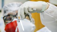 A healthcare worker wearing an Indonesian flag mask to mark the country's 76th Independence Day, prepares a dose of China's Sinovac Biotech vaccine against the coronavirus disease (COVID-19) during a mass vaccination program in Jakarta, Indonesia, August 17, 2021. REUTERS/Ajeng Dinar Ulfiana