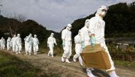 Officials in protective suits head to a poultry farm for a suspected bird flu case in Higashikagawa, western Japan, in this photo taken by Kyodo November 8, 2020. Mandatory credit Kyodo/via REUTERS/File Photo