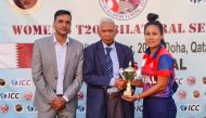 Qatar Cricket Association Operations Manager Manzoor Ahmad hands best player of the match award to Nepal's Rubina Chhetry.