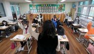 Children attend a class at an elementary school in Daejeon, South Korea, November 22, 2021. Yonhap via REUTERS

