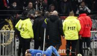 Olympique de Marseille's Dimitri Payet goes down after being hit by a water bottle thrown by a fan REUTERS/Benoit Tessier