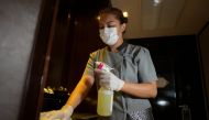 A hotel worker sprays disinfectant as a precaution against the coronavirus disease (COVID-19) at Athenee Hotel in Bangkok, Thailand, November 22, 2021. Picture taken November 22, 2021. REUTERS/Athit Perawongmetha