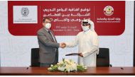 Nasser Al Muhannadi, Director of Finance and Administrative Affairs at MoCI, and Dr. Clyde Wilcox, Dean of Georgetown University in Qatar, during the signing ceremony.