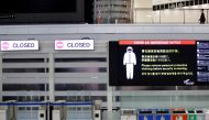 A notice about COVID-19 safety measures is pictured next to closed doors at a departure hall of Narita international airport on the first day of closed borders to prevent the spread of the new coronavirus Omicron variant in Narita, east of Tokyo, Japan, November 30, 2021. Reuters/Kim Kyung-Hoon/File Photo