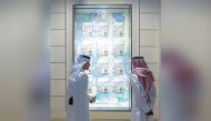 Qatari artists Fahad Al Maadheed and Nasser Alkubaisi, look at the specially dressed window at Galeries Lafayette Doha, recently.  