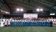 Aspire student athletes with the FIFA Arab Cup 2021 Trophy. 