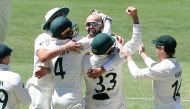 Australia's Nathan Lyon celebrates taking his 400th test wicket during day four of the First Ashes Test Jono Searle/AAP via REUTERS
