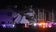 Emergency vehicles surround the site of an Amazon distribution warehouse with a collapsed roof, after storms hit the area of Edwardsville, Illinois, U.S. December 10, 2021. REUTERS/Lawrence Bryant
