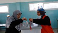 A Palestinian casts his ballot to vote in the municipal elections, near Jenin in the Israeli-occupied West Bank, December 11, 2021. REUTERS.