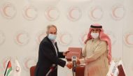 Secretary-General of QRCS Ali bin Hassan Al Hammadi and Vice-President of JNRCS Eng. Omar Abu-Goura exchanging documents after signing the agreement.