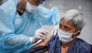 A woman gets a shot of a coronavirus disease (COVID-19) vaccine at the Central Vaccination Center as Thailand opens walk-in for first dose of the AstraZeneca vaccination scheme for elders, people with a minimum weight of 100 kilograms and pregnant women amid the coronavirus (COVID-19) outbreak in Bangkok, Thailand, July 23, 2021. REUTERS/Chalinee Thirasupa/File Photo