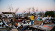 Nicolaus Kruse, 23, stands amongst the rubble of the home he grew up in after a devastating outbreak of tornadoes ripped through several U.S. states, in Mayfield, Kentucky, U.S. December 13, 2021. REUTERS/Cheney Orr