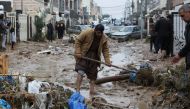 Residents clean a road full of mud after flash floods caused by torrential rains in Erbil, Iraq, December 17,2021. REUTERS/Azad Lashkari
