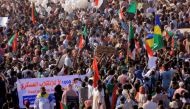 Protesters march during a rally from Khartoum North to Omdurman against military rule following last month's coup, in Khartoum, Sudan. December 13,2021. REUTERS.