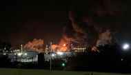 View from the road of a fire at petrochemical company ExxonMobil's refinery near Houston in Baytown, Texas, U.S., December 23, 2021 in this image obtained from social media. Molly Fitzpatrick via REUTERS