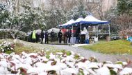 People line up in the snow for nucleic acid testing at a residential compound under lockdown following the coronavirus disease (COVID-19) outbreak in Yanta district of Xian, Shaanxi province, China December 25, 2021. Picture taken December 25, 2021. cnsphoto via REUTERS