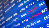 A screen showing cancelled flights is seen at John F. Kennedy International Airport during the spread of the Omicron coronavirus variant in Queens, New York City, U.S., December 26, 2021. REUTERS.