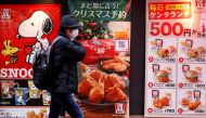 A man wearing a protective mask, amid the coronavirus disease (COVID-19) outbreak, walks past a Kentucky Fried Chicken (KFC) restaurant in Tokyo, Japan, December 14, 2021. REUTERS/Kim Kyung-Hoon/File Photo