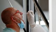 A man is tested as a mandatory measure for arriving passengers to prevent the spread of the coronavirus disease (COVID-19) at the international airport in Phuket, Thailand November 29, 2021. REUTERS/Jorge Silva/File Photo