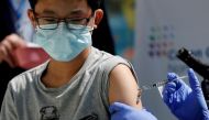Brendan Lo (13) receives a dose of the Pfizer-BioNTech vaccine for the coronavirus disease (COVID-19) at Northwell Health's Cohen Children's Medical Center in New Hyde Park, New York, U.S., May 13, 2021. REUTERS/Shannon Stapleton/File Photo



