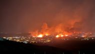 Buildings burn as a wind-driven grass fire destroys hundreds of homes, displaces thousands, as seen from Denver, Colorado, U.S. December 30, 2021. Gregg Corella/Handout via REUTERS