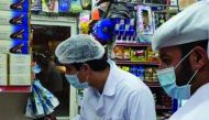 Officials conducting inspections in a shop.