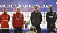 Besiktas coach Onder karaveli (second left) and Antalyaspor’s coach Alfons Groenendijk (third left) pose for a photograph with players during a press conference in Doha, yesterday.
