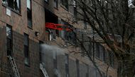 Emergency personnel from the FDNY respond to an apartment building fire in the Bronx borough of New York City, U.S., January 9, 2022. REUTERS/Lloyd Mitchell
