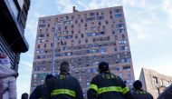:Firefighters watch a news conference at a multi level apartment building following a fire, in the Bronx borough of New York City, New York, U.S. January 10, 2022. REUTERS/Carlo Allegri
