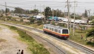 A Diesel Mobile Unit (DMU) train of the Nairobi Commuter Rail Service (NCRS) operated by the Kenya Railway Corporation (KRC) from Embakasi to Nairobi rides past electricity power lines near the Donholm station in Nairobi, Kenya January 11, 2022. REUTERS/Monicah Mwangi