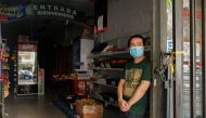 A seller waits for costumers at his shop during a blackout, amid a heat wave, in Buenos Aires, Argentina January 11, 2022. REUTERS/Agustin Marcarian
