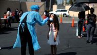 Alisson Argueta, 8, is given a coronavirus disease (COVID-19) test at a back-to-school clinic in South Gate, Los Angeles, California, U.S., August 12, 2021. REUTERS/Lucy Nicholson/File Photo