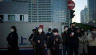 People wearing protective masks walk on a street, following new cases of the coronavirus disease (COVID-19), in SHANGHAI, China January 14, 2022. REUTERS/Aly Song
