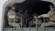 Kyrgyz servicemen of the Collective Security Treaty Organisation (CSTO) peacekeeping forces ride in the back of a military truck during their return from Kazakhstan, in Chui Region, Kyrgyzstan January 14, 2022. REUTERS/
