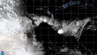 A white plume rises over Tonga when the underwater volcano Hunga Tonga-Hunga Ha'apai erupted, in this still image obtained from an animated GIF from the Cooperative Institute for Research in the Atmosphere (CIRA) and NOAA, January 15, 2021. CIRA/NOAA/Handout via REUTERS.