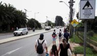 People evacuate the coastline in Chile following a tsunami preventive advisory generated by local authorities, after an underwater volcano eruption on the island of Tonga, at the South Pacific, La Serena, Chile, January 15, 2022. Reuters/Alejandro Pizarro Ubilla