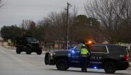 Law enforcement vehicles are seen in the area where a man has reportedly taken people hostage at a synagogue during services that were being streamed live, in Colleyville, Texas, U.S. January 15, 2022. Reuters/Shelby Tauber