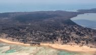 A general view from a New Zealand Defence Force P-3K2 Orion surveillance flight shows heavy ash fall over Nomuka in Tonga. Picture taken January 17, 2022. New Zealand Defence Force/Handout via Reuters