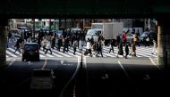 People wearing protective face masks walk on a pedestrian crossing, amid the coronavirus disease (COVID-19) pandemic, in Tokyo, Japan January 19, 2022. REUTERS/Issei Kato