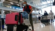 FILE PHOTO: First group of foreign tourists arrive at Suvarnabhumi Airport during the first day of the country's reopening campaign, part of the government's plan to jump start the pandemic-hit tourism sector in Bangkok, Thailand November 1, 2021. REUTERS/Soe Zeya Tun/
