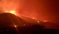 Wildfire burns in Rocky Point, Monterey County, California, U.S., in this handout photo taken over the night of January 21st or 22nd, 2022. DEBI LORENC/Handout via REUTERS
