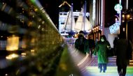 Visitors wearing protective face masks walk on a pedestrian deck, amid the coronavirus disease (COVID-19) pandemic, in Tokyo, Japan January 22, 2022. Reuters/Issei Kato/File Photo