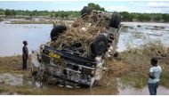 Locals look at a wreck washed away during Tropical Storm Ana on the flooded Shire river, an outlet of Lake Malawi at the village of Thabwa in Chikwawa district, southern Malawi, January 26, 2022. REUTERS/Eldson Chagara/File Photo