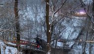 Vehicles sit on a collapsed bridge in Pittsburgh, Pennsylvania, U.S. January 28, 2022, in this image obtained from social media. Greg Barnhisel via REUTERS