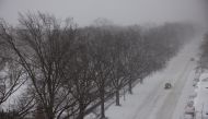 Cars drive along the snow-covered Central Park West avenue after a powerful Nor'easter storm hit the region in New York City, U.S., January 29, 2022. REUTERS/Caitlin Ochs
