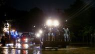 A bulldozer carries people across a flooded street after heavy rains in Caieiras, Brazil January 30, 2022. REUTERS/Carla Carniel
