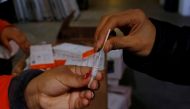 FILE PHOTO: A staff member uses a home coronavirus disease (COVID-19) test to check the heath of volunteers. REUTERS/Brian Snyder/File Photo
