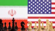 Chess pieces are seen in front of displayed Iran's and U.S. flags in this illustration taken January 25, 2022. REUTERS/Dado Ruvic/Illustration/File Photo
